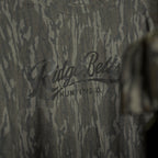 Camo-patterned shirt with 'Ridge Belts' branding and a cap in the foreground.